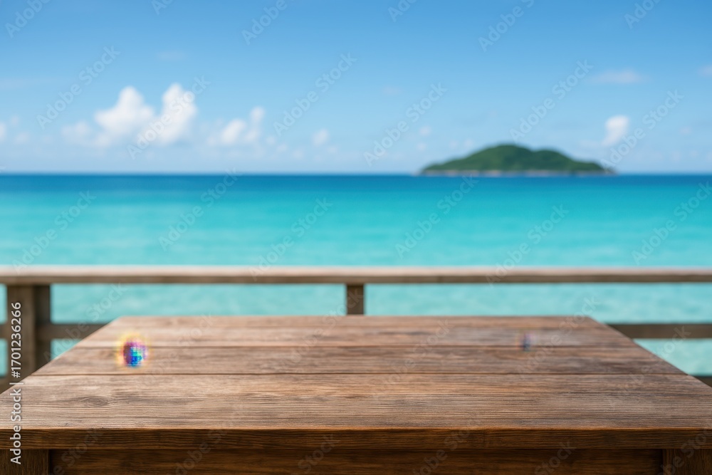 Fototapeta premium Empty rustic wooden tabletop overlooking a calm turquoise sea and distant island under clear blue sky with copy space for product mockups