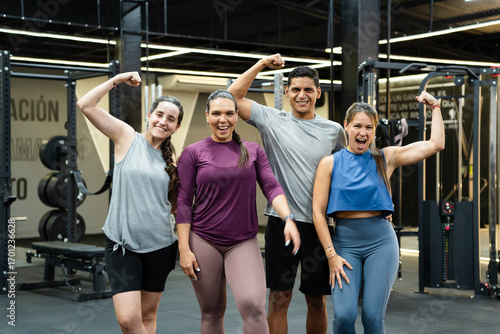 Happy athletes flexing their muscles in the gym, celebrating achievements after an intense workout, radiating confidence and energy