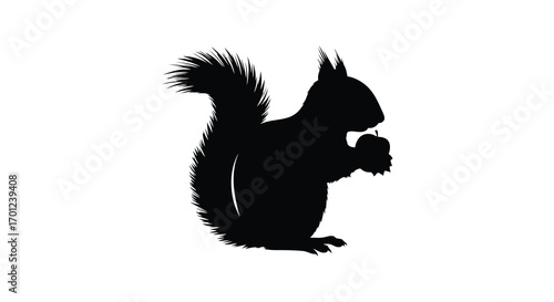 a squirrel silhouette holding an acorn in its paws