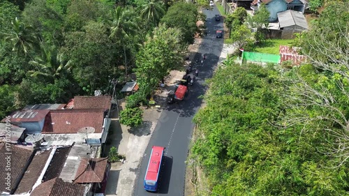 Aerial view of asphalt road repair with trial compaction process, testing surface quality before final paving. Infrastructure construction footage