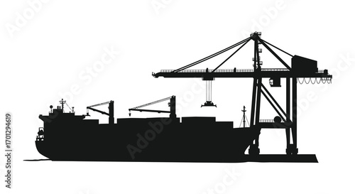 cargo ship docked near large crane silhouette