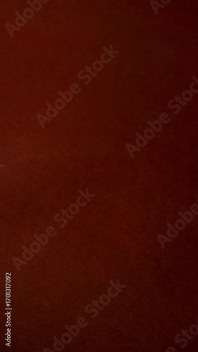 Vertical video of decorative gourds and pumpkins placed in the middle of vibrant dark orange surface.