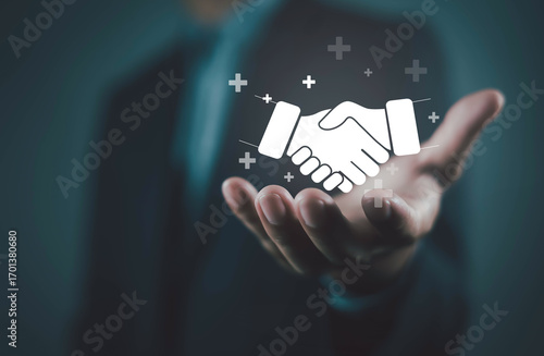 Businessman holding handshake icon symbolizing partnership, trust, business deal, collaboration, and corporate agreement. Represents teamwork, negotiation, success, and long-term business relationship