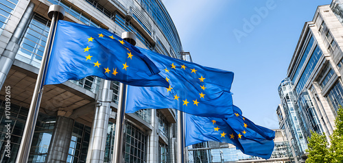European Union Flags Waving Outside a Modern Building Under Clear Blue Sky During Daylight in a Bustling City