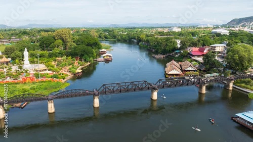Stunning Hyperlapse Captures Iconic Bridge Over Serene River Kwai in Kanchanaburi with Aerial Views of Lush Landscape and Water