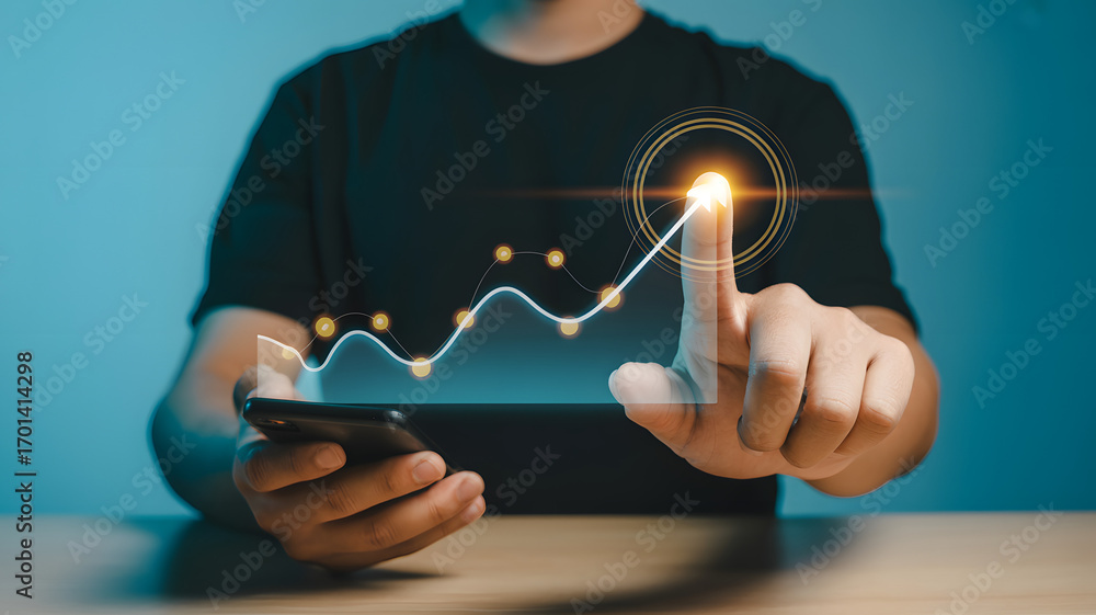 Fototapeta premium Man tracks upward financial growth on holographic chart using smartphone analytics for business success