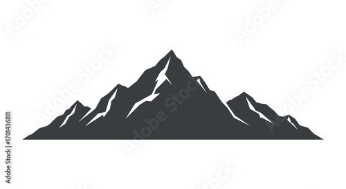 a majestic mountain peak rises sharply against clear sky