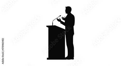 a silhouette figure stands speaking at podium