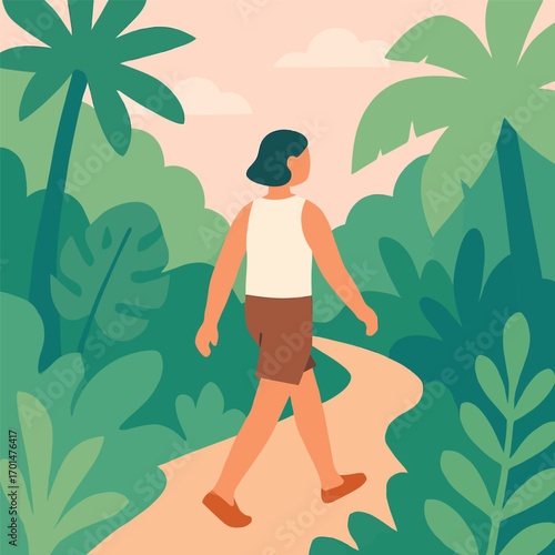 A person walks along a winding path through a lush, green tropical forest.