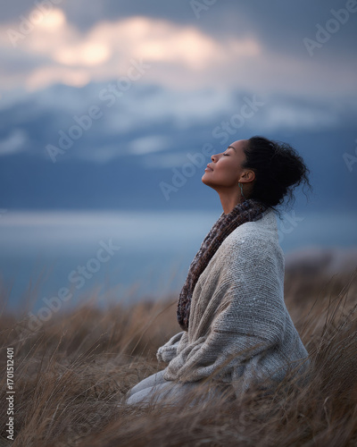 Winter Self-Care Rituals, finding peace in nature while meditating in cold mountain air wrapped in warm textured layers.