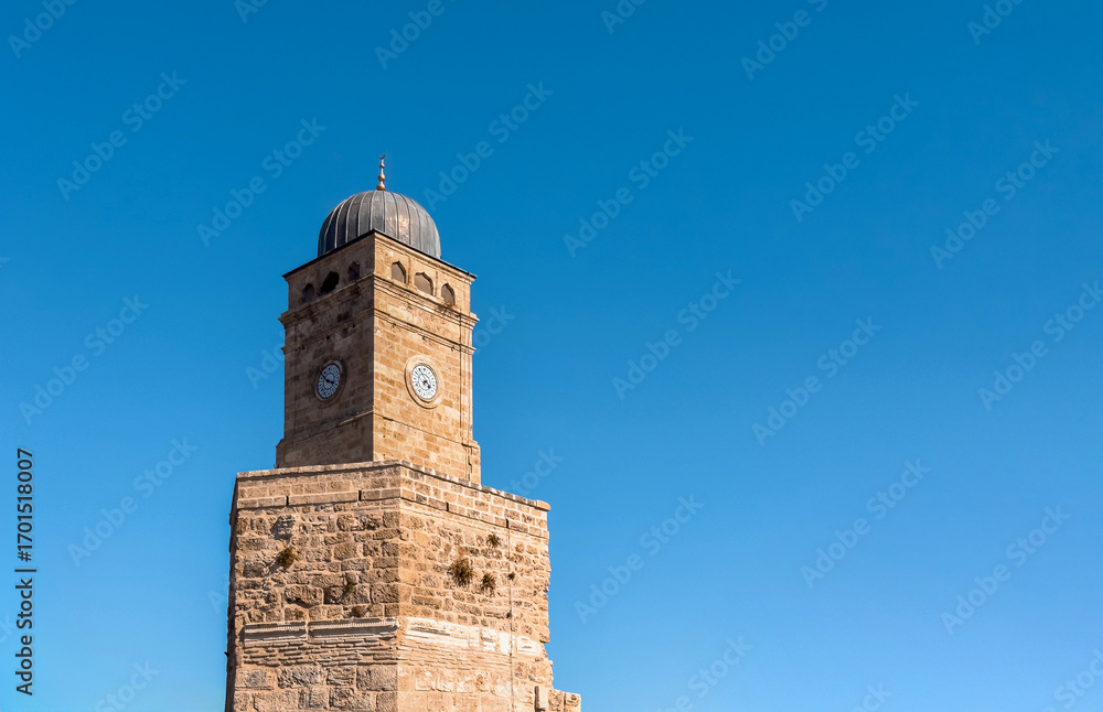 Fototapeta premium The historic clock tower in front of the deep blue sky in Antalya
