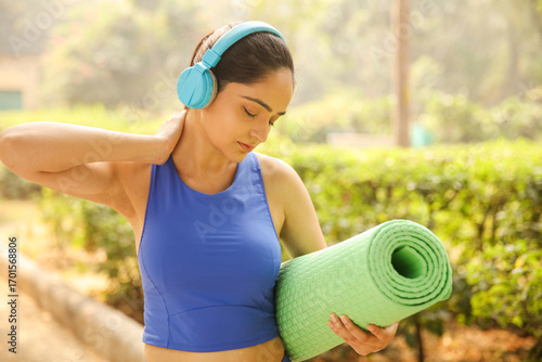 Fitness Woman Holding A Green Mat
