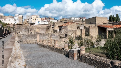 Timelapse of visitors walking through the narrow ancient streets of Herculaneum, the Roman city destroyed by the eruption of Mount Vesuvius in 79 AD. Naples, Italy.