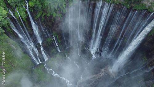 tumpak sewu waterfall with fog in the forest