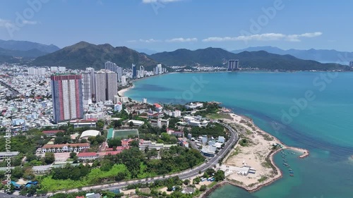 Aerial panoramic view of Northern part of Nha Trang city with coastal road, sand beach and mountains, Vietnam.