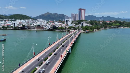 Aerial view of Cau Tran Phu bridge across Cai river and Northern part of Nha Trang city with mountains, Vietnam.