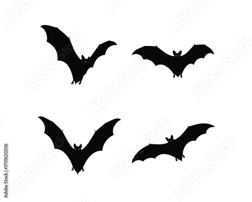 Four silhouettes of flying bats in different poses against a white background for halloween decorations