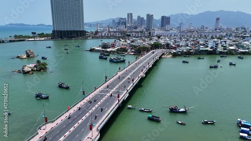 Aerial panoramic view of Cau Xom Bong bridge across Cai river with boats in Nha Trang city, Vietnam.