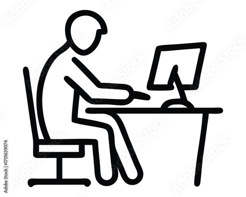 A businessman sits at his desk, working on