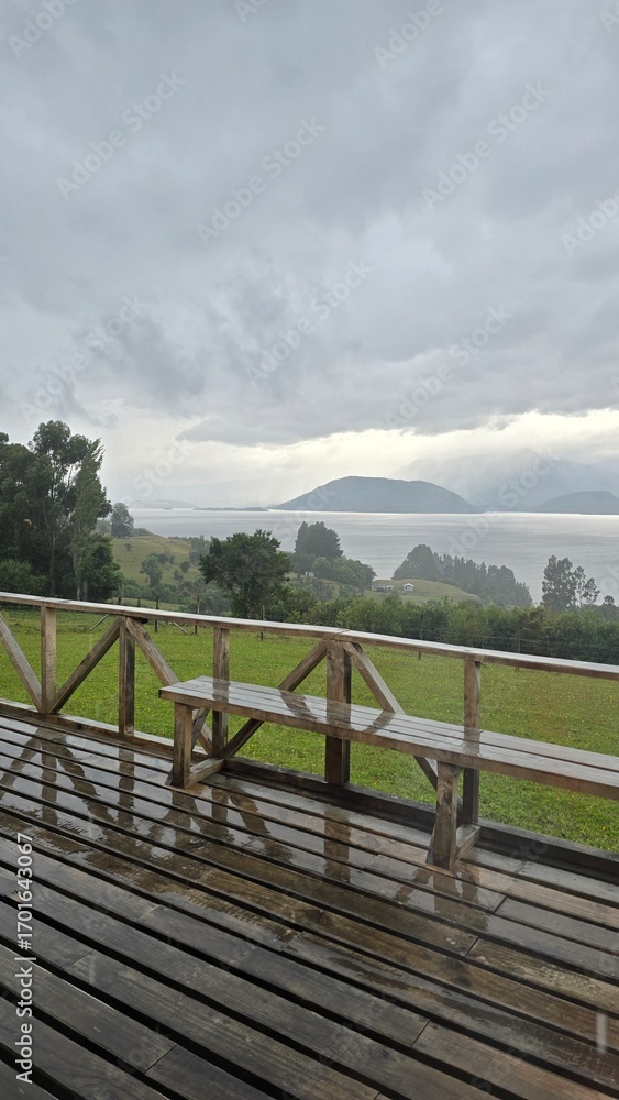 Fototapeta premium Beautiful view of Lago Ranco in Chile on a cloudy day, with calm waters, mountains, and forested shores creating a peaceful natural landscape.