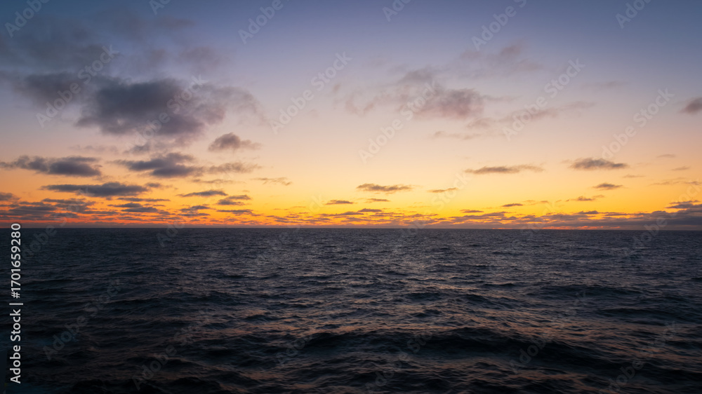 Naklejka premium Sunset and Blue Hour at sea, over the Atlantic Ocean, August 2025.