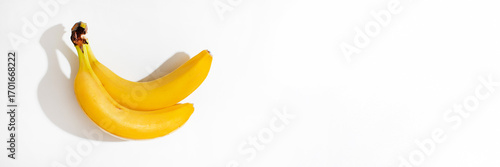 Bild auf Leinwand Two radiant bananas bask in ethereal light, embodying tropical nostalgia and pla