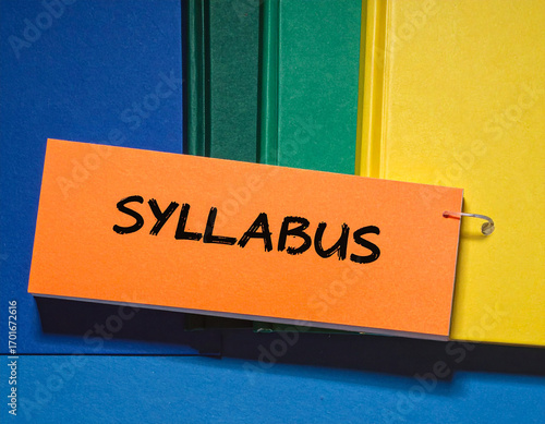 Orange tag with syllabus text on colorful binders black text blue