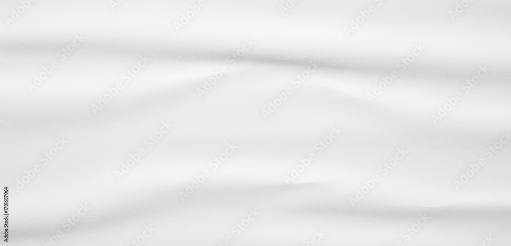 Naklejka premium White fabric with soft folds and gentle shadows creates a smooth abstract background with elegant draping texture that feels calm, minimal, and refined.
