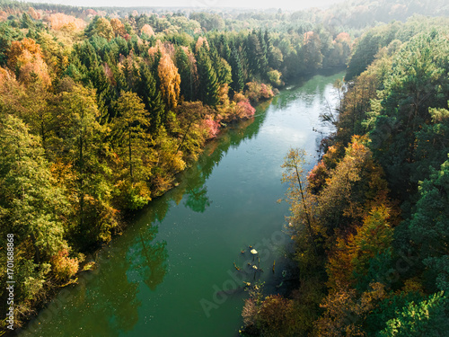 Autumn colorful forest and river Brda at sunrise in Poland.