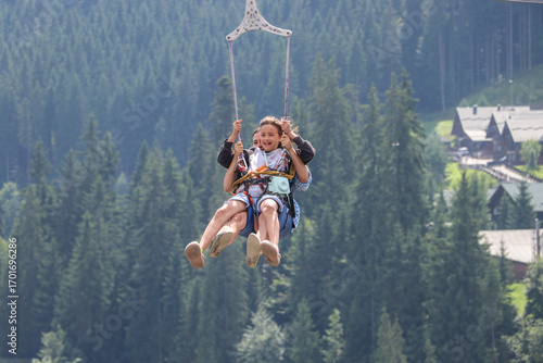 Quadro su tela Childs joy in flight. Zipline over the mountains.