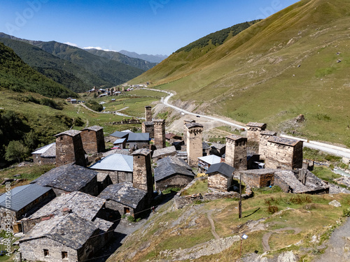 Aerial view of Mestia showing Svan towers, houses, and a flowing river in Georgia