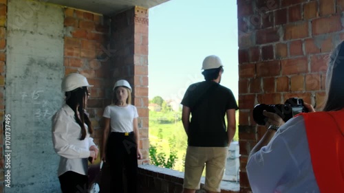 Wallpaper Mural Engineers and worker stand at window in unfinished building. Colleagues inspect area and draw conclusions about results of work process Torontodigital.ca