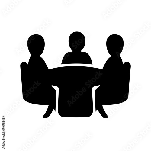 Three people sitting around a table in a meeting or conference