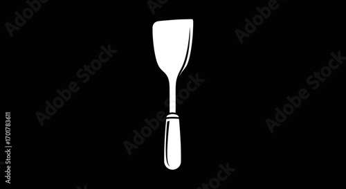 White spatula kitchen utensil on black background for cooking and food preparation.