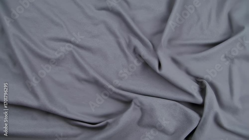 Gray fabric gently shifting and rippling