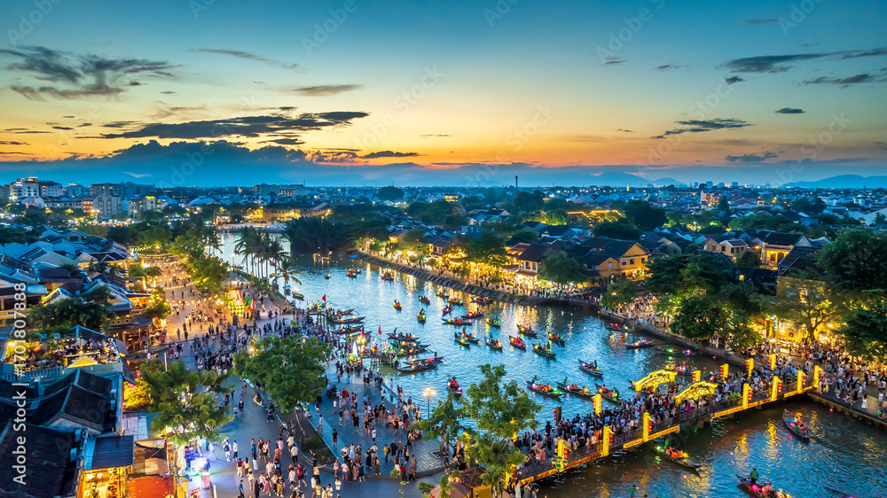 Fototapeta premium Aerial view of Hoi An ancient town at twilight, Vietnam. Famous old town for travel in Vietnam, UNESCO World Heritage.