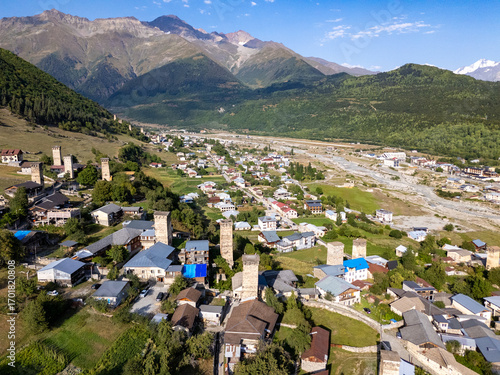 Mestia, Georgia, Ushbis Shesakhvevi street showcasing svan towers and Caucasus mountains