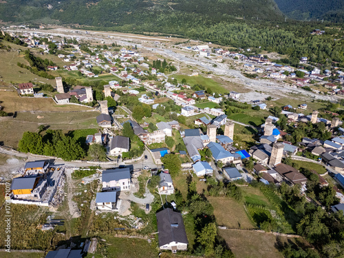 Mestia, Georgia, Ushbis Shesakhvevi street showcasing svan towers and Caucasus mountains
