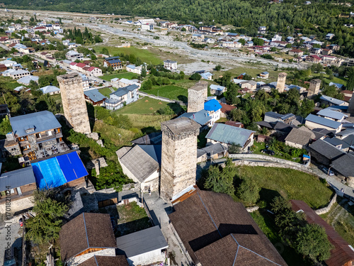 Mestia, Georgia, Ushbis Shesakhvevi street showcasing svan towers and Caucasus mountains