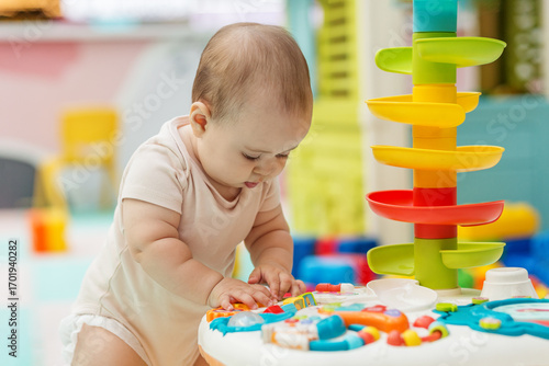Baby exploring sensory toy table for development learning