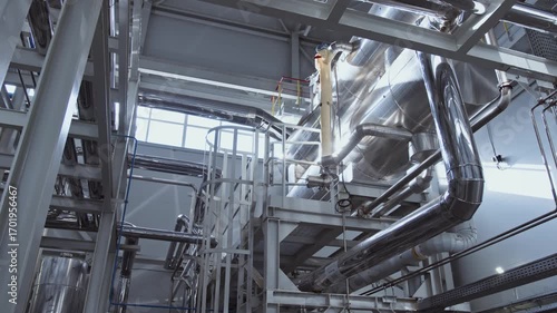 Chrome-plated clean shiny pipes in the factory. A pipeline at a chemical plant.