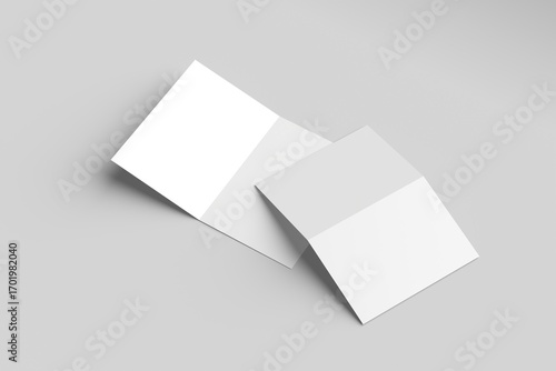 Bi-fold brochure mockup featuring two blank brochures on a gray surface.