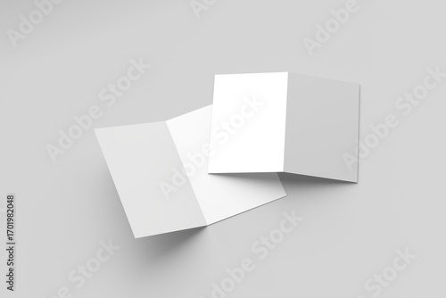 Bi-fold brochure mockup featuring two blank brochures on a gray surface.