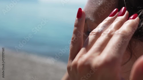 Wallpaper Mural Sunscreen, woman, beach, applying facial cream for skin protection on summer day Torontodigital.ca