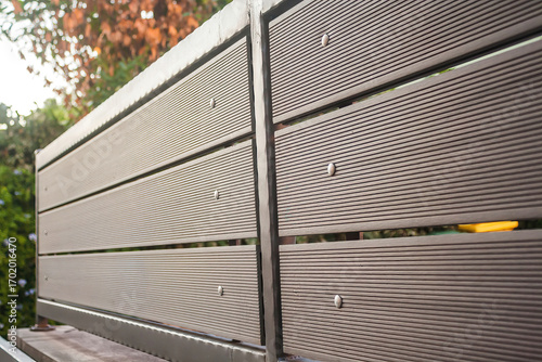 Horizontal PVC slat fence with metal frame