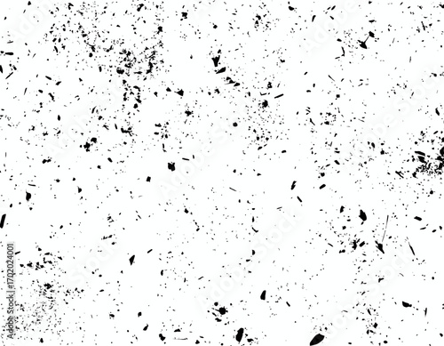 Abstract texture featuring a speckled pattern of black dots and splatters scattered across a white background, creating a distressed and grainy effect.