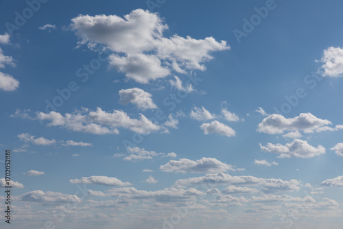 Blue sky with scattered fair-weather clouds and perspective clouds 
