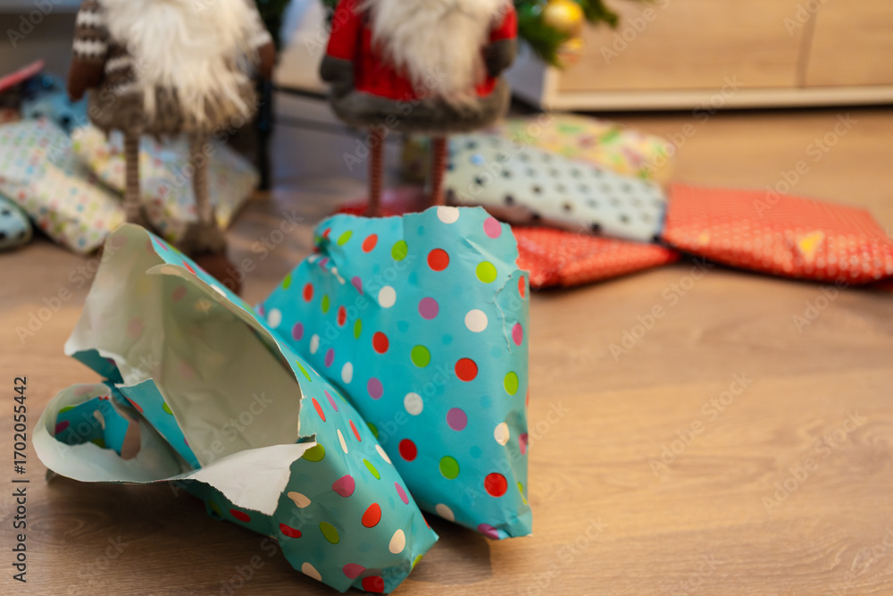 Fototapeta premium Opened christmas gift lies on floor near christmas tree