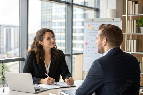Businesswoman interviewing male job candidate