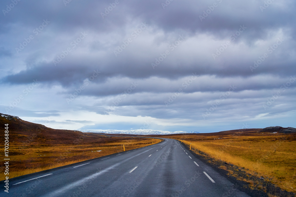 Naklejka premium Road trip view with long road by the ring road plan for travel by car in Iceland , Amazing view with high layer cloud.